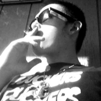 Ben Spangler wearing a Touchers t-shirt and shades while smoking